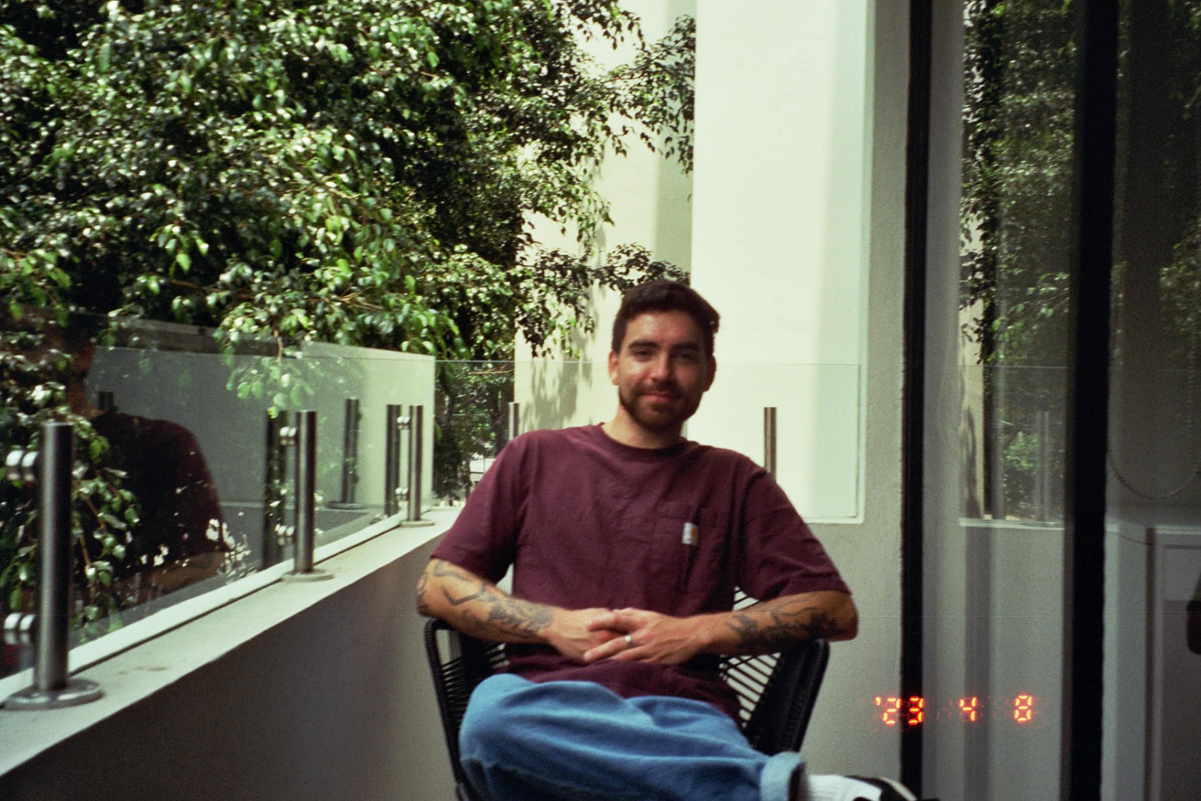 Me sitting in a chair on a balcony in Mexico